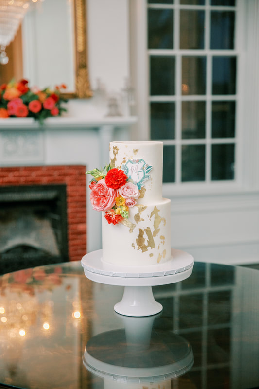 Two-tier wedding cake with gold foil and flowers inspired by Hawaii by Sweet Cakes by Sandra. 