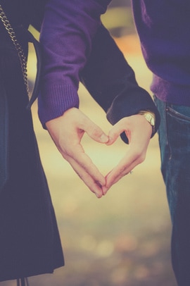 Engaged Couple Holding Heart with Hands